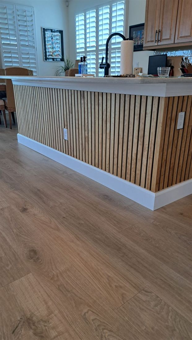 Kitchen island wrapped in vertical wood slats