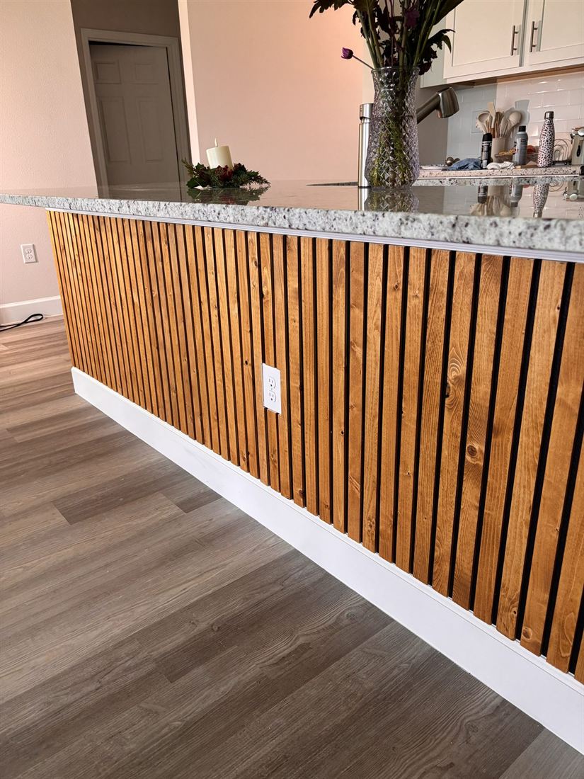 Kitchen island after: wood slat wall cladding