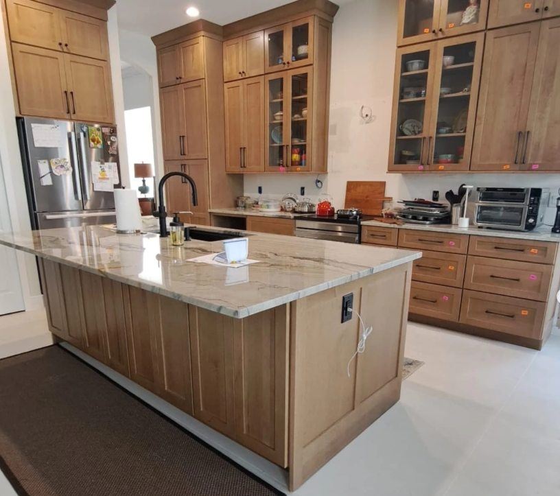 Custom stained wood kitchen cabinetry and island